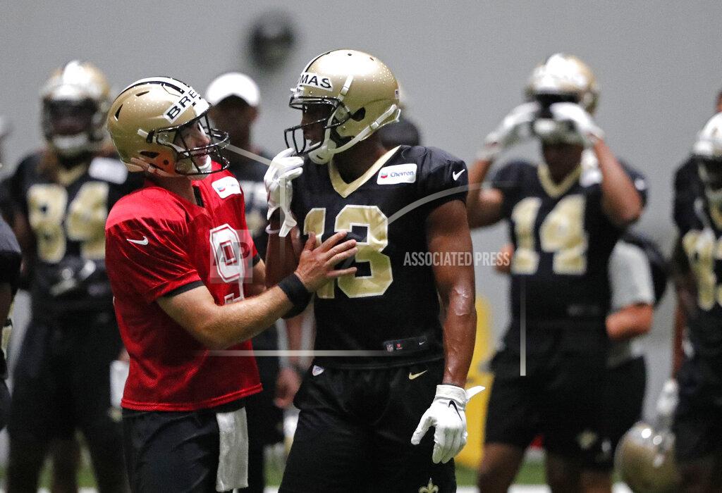 New Orleans Saints quarterback Drew Brees (9) talks with wide receiver Michael Thomas (13) during training camp at their NFL football training facility in Metairie, La., Thursday, Aug. 1, 2019. (AP Photo/Gerald Herbert)