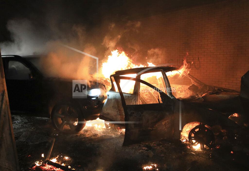 Peter Morrison FILE - In this Wednesday, April 7, 2021 file photo, hijacked cars burn at the peace wall on Lanark Way as rioting broke out in West Belfast, Northern Ireland. The chaotic scenes during a week of violence on the streets of Northern Ireland have stirred memories of decades of Catholic-Protestant conflict, known as “The Troubles.” A 1998 peace deal ended large-scale violence but did not resolve Northern Ireland’s deep-rooted tensions. (AP Photo/Peter Morrison, File)