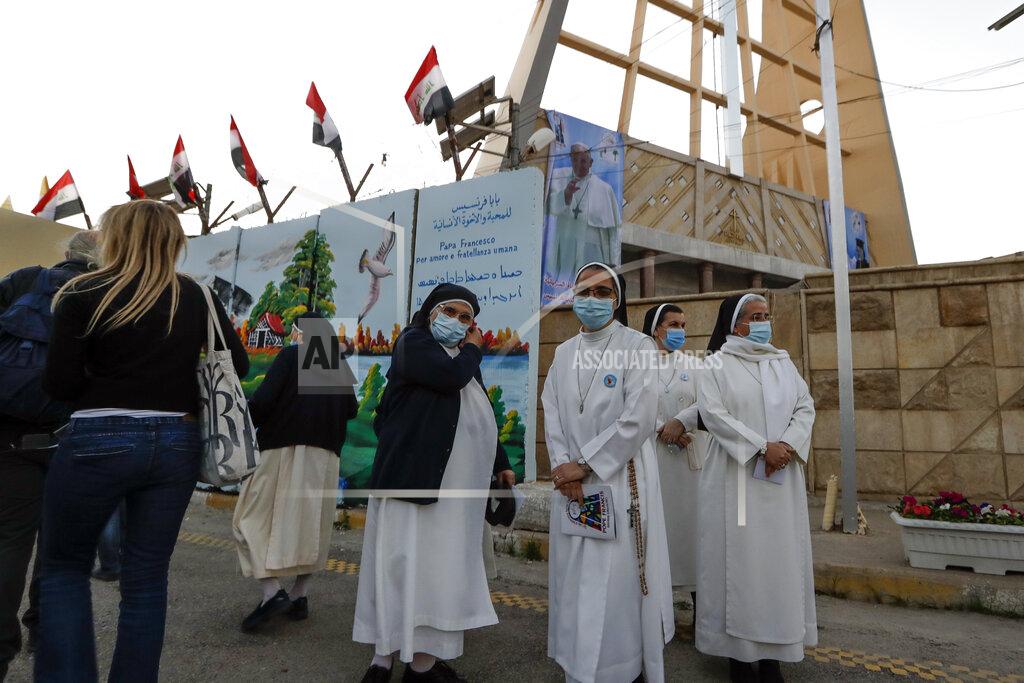 Andrew Medichini Nuns wait to see Pope Francis outside the Sayidat al-Nejat (Our Lady of Salvation) Cathedral, in Baghdad, Iraq, Friday, March 5, 2021. Pope Francis has honored victims of one of Iraq's most brutal massacres of Christians by Islamic militants. He is making a visit to Baghdad's Our Lady of Salvation Cathedral, where he has prayed and spoke with priests, seminarians and religious sisters. In 2010, al-Qaida-linked militants gunned down worshippers at the church in an attack that left 58 people dead. (AP Photo/Andrew Medichini)