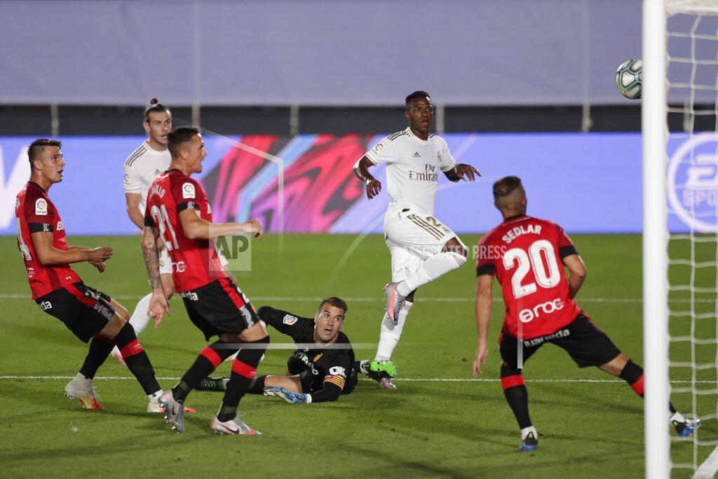 Bernat Armangue Real Madrid's Vinicius Junior, second right, kicks the ball to scoring the opening goal during the Spanish La Liga soccer match between Real Madrid and Mallorca at Alfredo di Stefano stadium in Madrid, Spain, Wednesday, June 24, 2020. (AP Photo/Bernat Armangue)