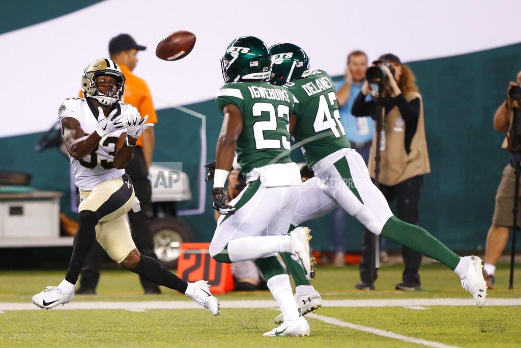 Noah K. Murray New Orleans Saints' Cyril Grayson (83) catches a pass in front of New York Jets' Godwin Igwebuike (23) and another defender during the second half of a preseason NFL football game Saturday, Aug. 24, 2019, in East Rutherford, N.J. (AP Photo/Noah K. Murray)