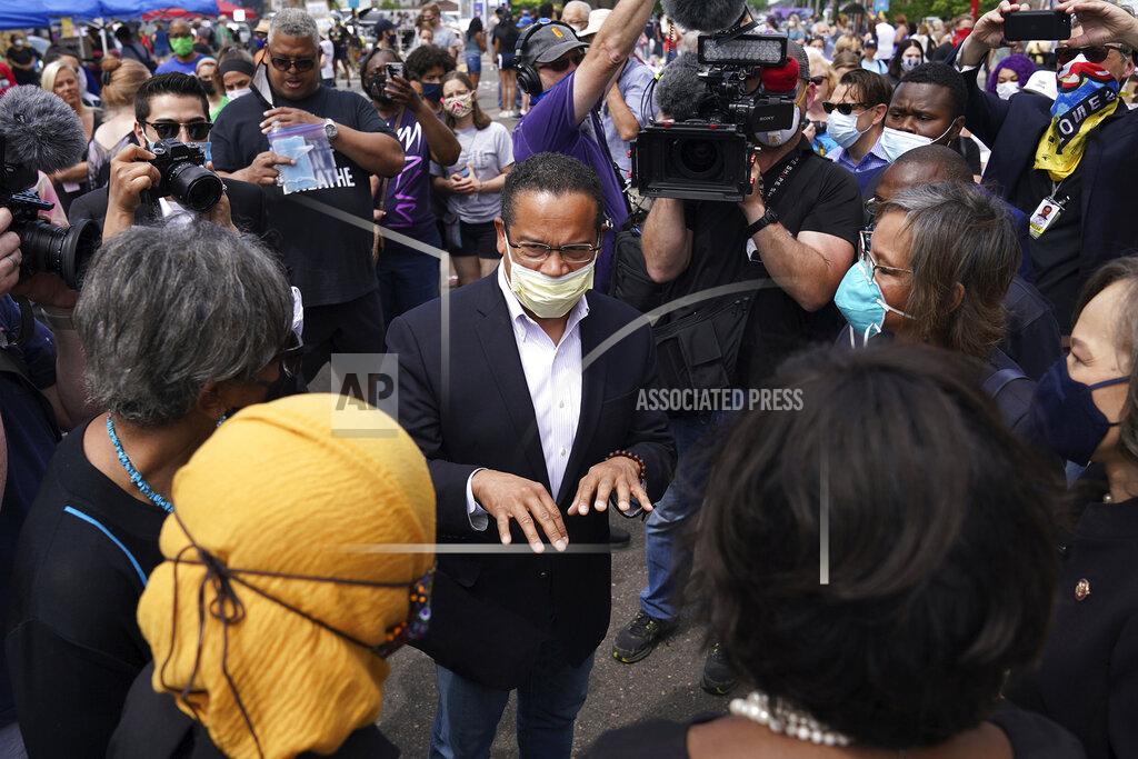 Anthony Souffle FILE - In this June 4, 2020 file photo, Minnesota Attorney General Keith Ellison, center, speaks with Rep. Ilhan Omar, D-Minn., and members of the Congressional Black Caucus as they visited the site of George Floyd's death in south Minneapolis. Taking over as lead prosecutor in George Floyd's death, is giving Ellison a national platform to talk about race in America. And while Ellison is careful not to talk about details of the criminal cases against four Minneapolis police officers, he's grabbing the opportunity to raise issues about police reform that he's worked on in the past. (Anthony Souffle/Star Tribune via AP, File)