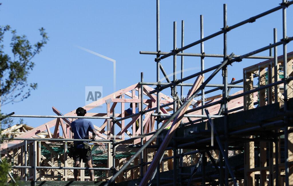 Mark Baker Builders work on a construction site as level four COVID-19 restrictions are eased in Christchurch, New Zealand, Tuesday, April 28, 2020. New Zealand eased its strict lockdown restrictions to level three at midnight to open up certain sections of the economy but social distancing rules will still apply. (AP Photo/Mark Baker)