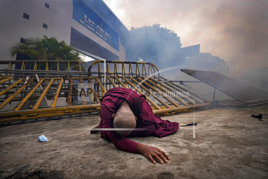 Eranga Jayawardena FILE- A Buddhist nun falls next to a barricade after inhaling tear gas during a protest against the economic crisis outside police headquarters in Colombo, Sri Lanka, June 9, 2022. Prime Minister Ranil Wickremesinghe told Parliament on Wednesday that Sri Lanka’s economy has collapsed after months of shortages of food, fuel and electricity. (AP Photo/Eranga Jayawardena, File)