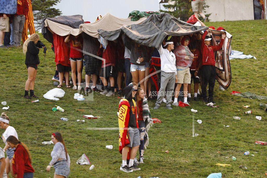 Charlie Neibergall Students huddle under blankets during a lightning delay in the first half of an NCAA college football game between Iowa State and Iowa, Saturday, Sept. 14, 2019, in Ames, Iowa. (AP Photo/Charlie Neibergall)