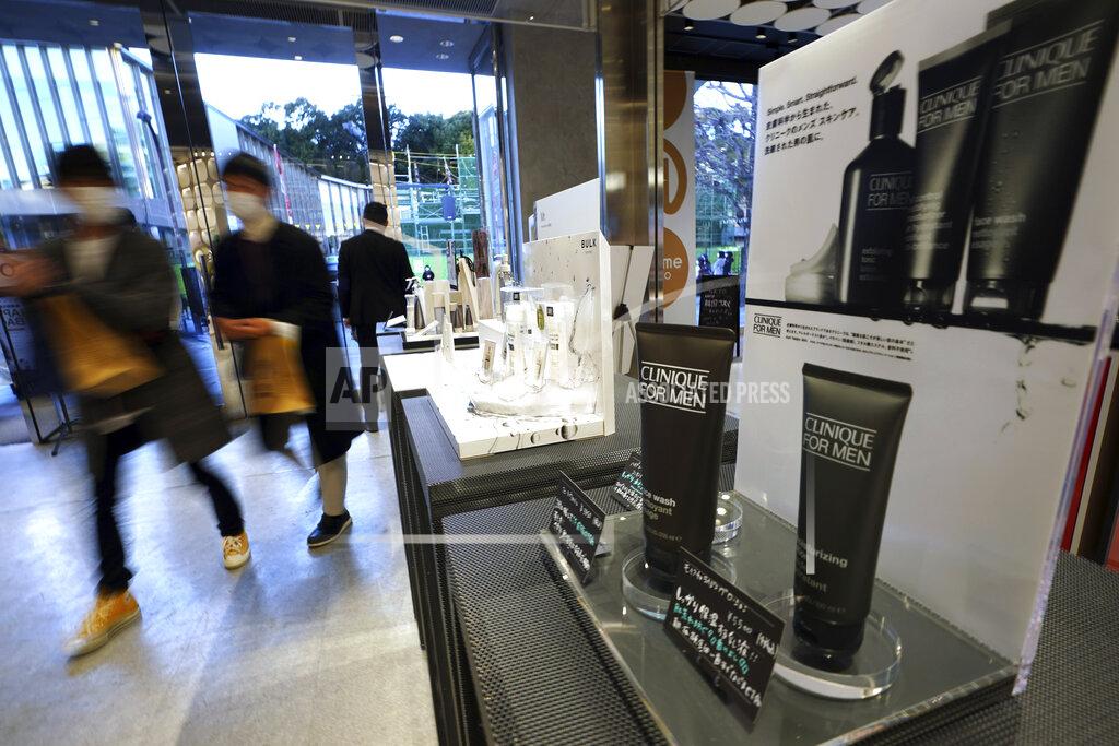 Eugene Hoshiko Visitors walk past some beauty products for men at @cosme TOKYO, a store selling a selection of cosmetics and makeup products including men's cosmetic, in Tokyo's Harajuku district Tuesday, Feb. 9, 2021. The coronavirus pandemic has been pushing businesses to the edge in Japan, but some in the men's beauty industry have seen an unexpected expansion in their customer base. Japanese businessmen in their 40s, 50s and 60s who had little interest in cosmetics before the pandemic are now buying makeup. (AP Photo/Eugene Hoshiko)