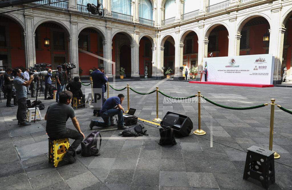 Eduardo Verdugo Mexican President Andres Manuel Lopez Obrador speaks at the National Palace in Mexico City, as the press keeps their distance, Sunday, April 5, 2020. Mexico's Treasury reduced its forecast for the year this week to a contraction of the Mexican economy, which was already in a technical recession. Mexico's government has broadened its shutdown of "non essential activities," and prohibited gatherings of more than 50 people as a way to help slow down the spread of COVID-19. (AP Photo/Eduardo Verdugo)