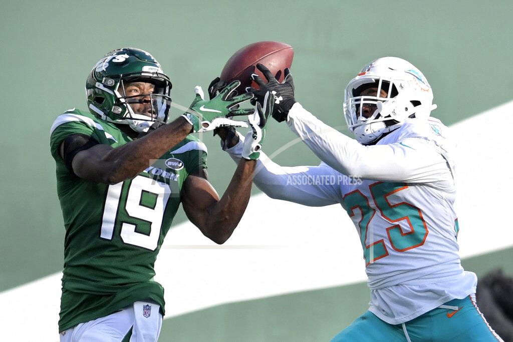 Bill Kostroun Miami Dolphins cornerback Xavien Howard (25) breaks up a s pass intended for New York Jets wide receiver Breshad Perriman (19) during the first half of an NFL football game, Sunday, Nov. 29, 2020, in East Rutherford, N.J. Howard leads the NFL this season with seven interceptions, and his shutdown skills have helped the Dolphins flummox foes with a blitz-happy scheme. He's the chief catalyst in a remarkable turnaround by Miami’s defense over the past 12 months.(AP Photo/Bill Kostroun)