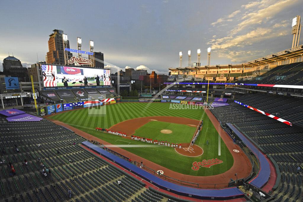 David Dermer Players and coaches for the New York Yankees and Cleveland Indians stand for the national anthem before the start of Game 1 of an American League wild-card baseball series, Tuesday, Sept. 29, 2020, in Cleveland. (AP Photo/David Dermer)