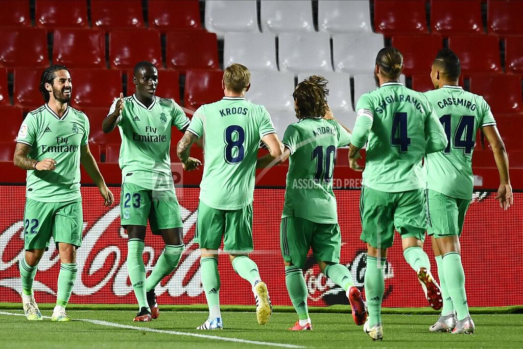 Jose Breton Real Madrid's Ferland Mendy, second left, celebrates after scoring with teammates the opening goal during the Spanish La Liga soccer match between Granada and Real Madrid at the Los Carmenes stadium in Granada, Spain, Monday, July 13, 2020. (AP Photo/Jose Breton)