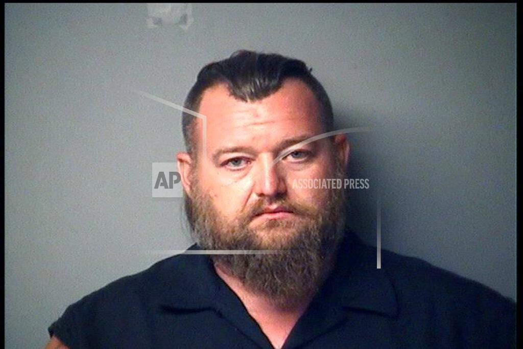 CORRECTS CHARGES - In a photo provided by the Antrim County Sheriff, William Null is shown in a booking photo. Null is one of several charged Thursday, Oct. 8, 2020, in state court for allegedly seeking to storm the Michigan Capitol and seek a “civil war.” (Antrim County Sheriff via AP)