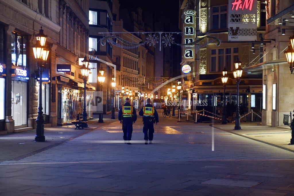 Zoltan Mathe FILE - In this Nov. 11, 2020, file photo, police officers control the traffic in downtown Budapest during the curfew of the state of emergency as part of the containment measures of COVID-19 in Budapest, Hungary. The European Union still hasn't completely sorted out its messy post-divorce relationship with Britain — but it has already been plunged into another major crisis. This time the 27-member union is being tested as Poland and Hungary block passage of its budget for the next seven years and an ambitious package aimed at rescuing economies ravaged by the coronavirus pandemic. (Zoltan Mathe/MTI via AP, File)
