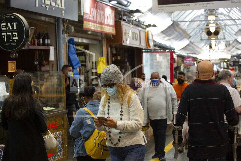 Maya Alleruzzo A woman uses her smart phone in the Mahane Yehuda market in Jerusalem, Wednesday, Dec. 23, 2020.In the early days of the pandemic, a panicked Israel began using a mass surveillance tool on its own people, tracking civilians’ mobile phones to halt the spread of the coronavirus. But months later, the tool’s effectiveness is being called into question and critics say its use has come at an immeasurable cost to the country’s democratic principles. (AP Photo/Maya Alleruzzo)