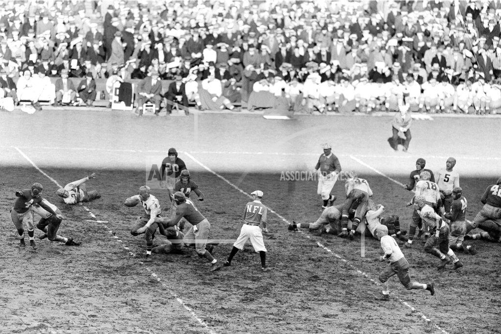 Uncredited FILE - In this Nov. 20, 1938, file photo, Green Bay Packers halfback Cecil Isbell (17) gains 10-yards against the New York Giants during the first quarter of a professional football game at the Polo Grounds in New York. (AP Photo)