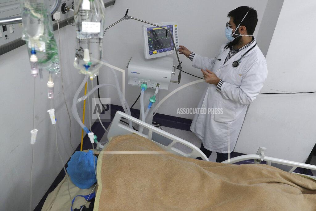A medical staffer checks the data of a COVID-19 patient on a screen at the intensive care unit of the Rafik Hariri University Hospital in Beirut, Lebanon, Friday, Jan. 22, 2021. Hospitals in Lebanon are reaching full capacity amid a dramatic surge in coronavirus cases across the crisis-hit Mediterranean nation even amid strict lockdown. (AP Photo/Bilal Hussein)
