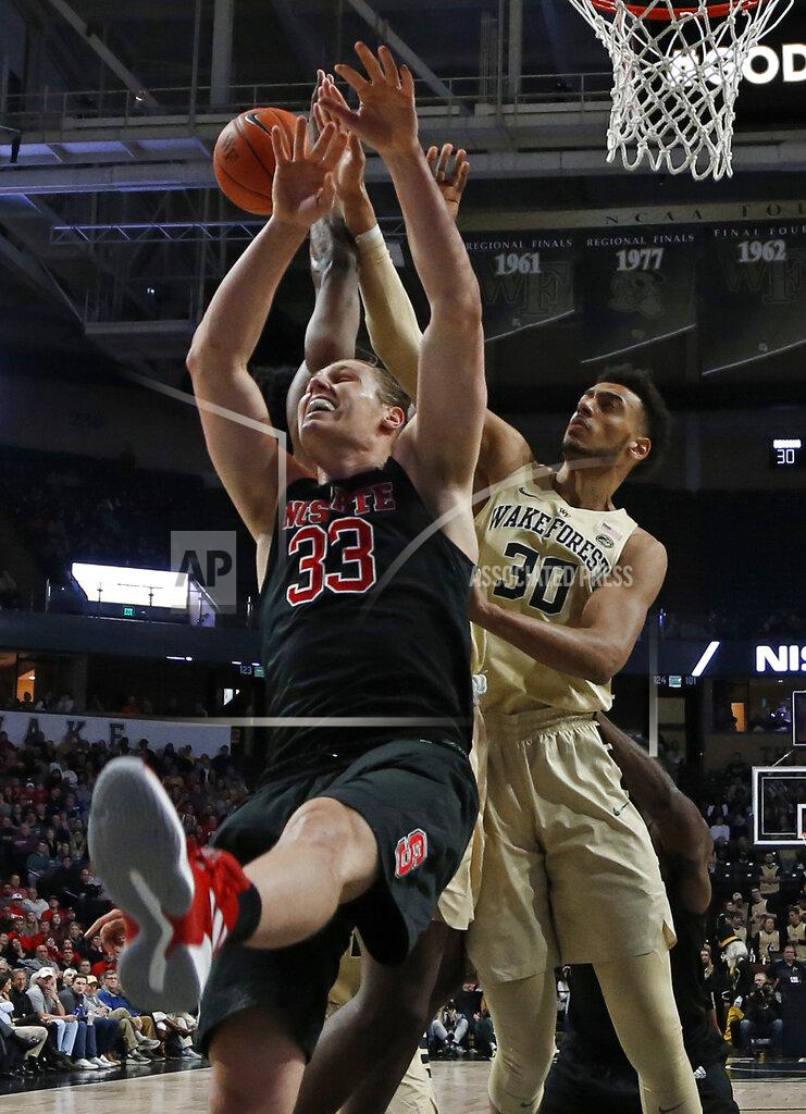 Chuck Burton North Carolina State's Wyatt Walker (33) and Wake Forest's Olivier Sarr (30) compete for a rebound during the first half of an NCAA college basketball game in Winston-Salem, N.C., Tuesday, Jan. 15, 2019. (AP Photo/Chuck Burton)
