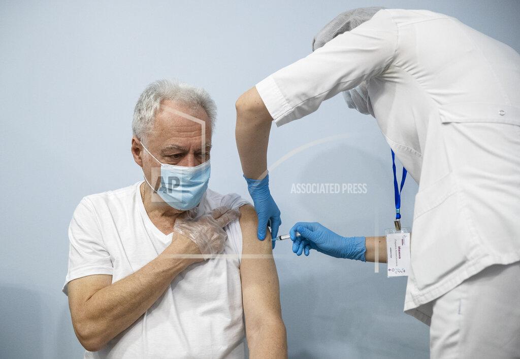 Pavel Golovkin A Russian medical worker, right, administers a shot of Russia's Sputnik V coronavirus vaccine to a patient in a vaccination center in Moscow, Russia, Wednesday, Jan. 20, 2021. Russia started a mass coronavirus vaccination campaign on Monday, Jan. 18. (AP Photo/Pavel Golovkin)