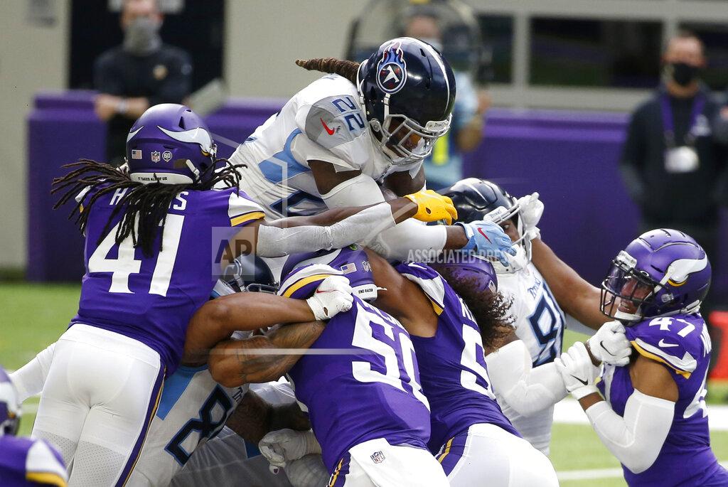Bruce Kluckhohn Tennessee Titans running back Derrick Henry (22) leaps over the pile for a first down during the first half of an NFL football game against the Minnesota Vikings, Sunday, Sept. 27, 2020, in Minneapolis. (AP Photo/Bruce Kluckhohn)