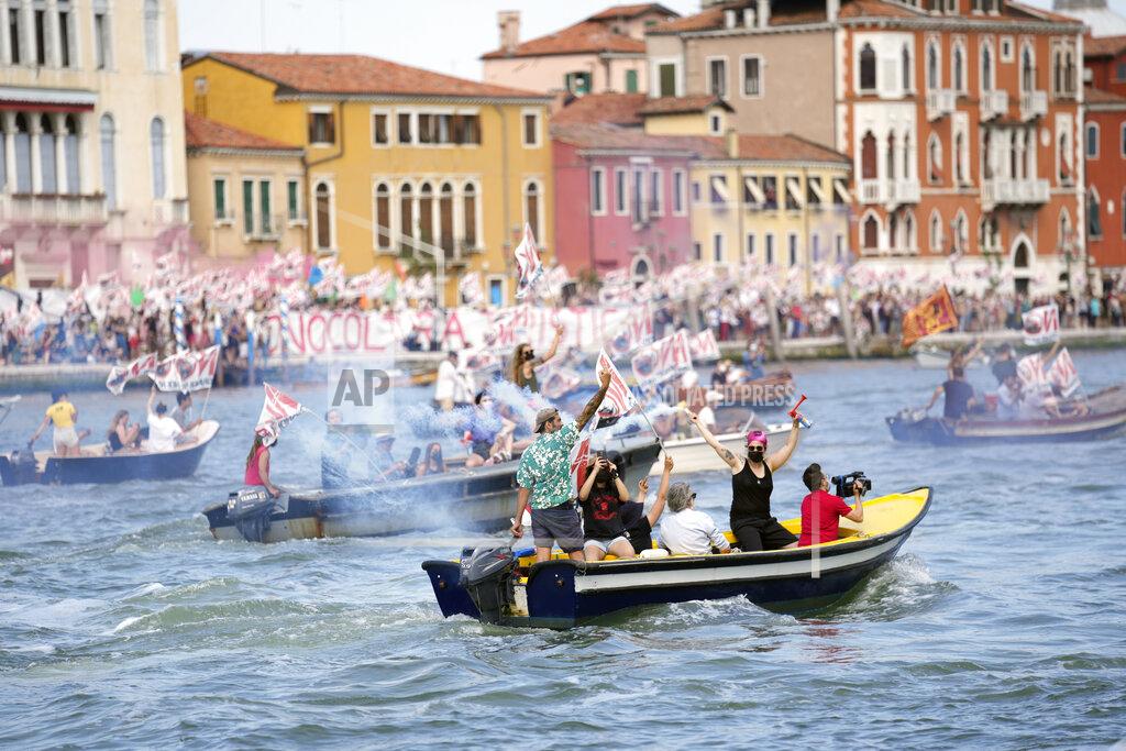 Antonio Calanni "No Big Ships" activists stage a protest as the MSC Orchestra cruise ship leaves Venice, Italy, Saturday, June 5, 2021. The 92,409-ton, 16-deck MSC Orchestra cruise ship, the first cruise ship leaving Venice since the pandemic is set to depart Saturday amid protests by activists demanding that the enormous ships be permanently rerouted out the fragile lagoon, especially Giudecca Canal through the city's historic center, due to environmental and safety risks. The ship passed two groups of protesters: pro-cruise advocates whose jobs depend on the industry as well as protesters who have been campaigning for years to get cruise ships out of the lagoon. The cruiser passed two groups of protesters: pro-cruise advocates whose jobs depend on the industry as well as protesters who have been campaigning for years to get cruise ships out of the lagoon. (AP Photo/Antonio Calanni)