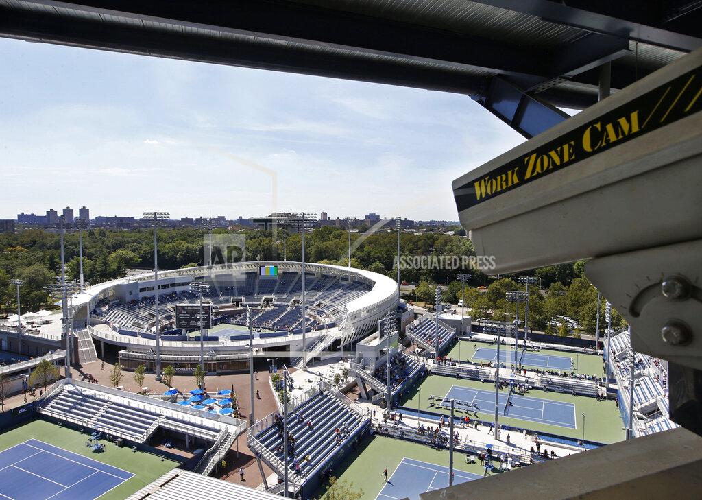Kathy Willens FILE - In this Aug. 24, 2016, file photo, a closed circuit construction camera peers out at the Grandstand stadium during qualifying rounds at the Billie Jean King National Tennis Center in New York. Nascent forms of crowd monitoring — like laser-driven density detection and camera-based line-length calculations — will likely grow faster in a post-pandemic era of live sports, (AP Photo/Kathy Willens, File)