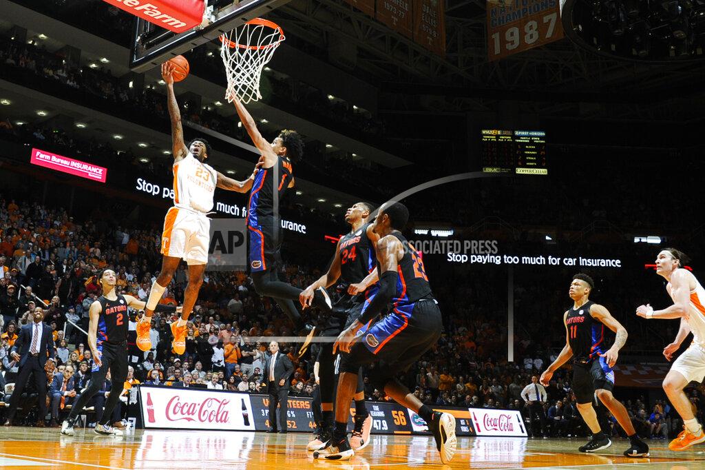 Calvin Mattheis Tennessee guard Jordan Bowden (23) goes for a layup as Florida guard Tre Mann (1) defends during an NCAA college basketball game in Knoxville, Tenn., on Saturday, Feb. 29, 2020. (Calvin Mattheis/Knoxville News Sentinel via AP)