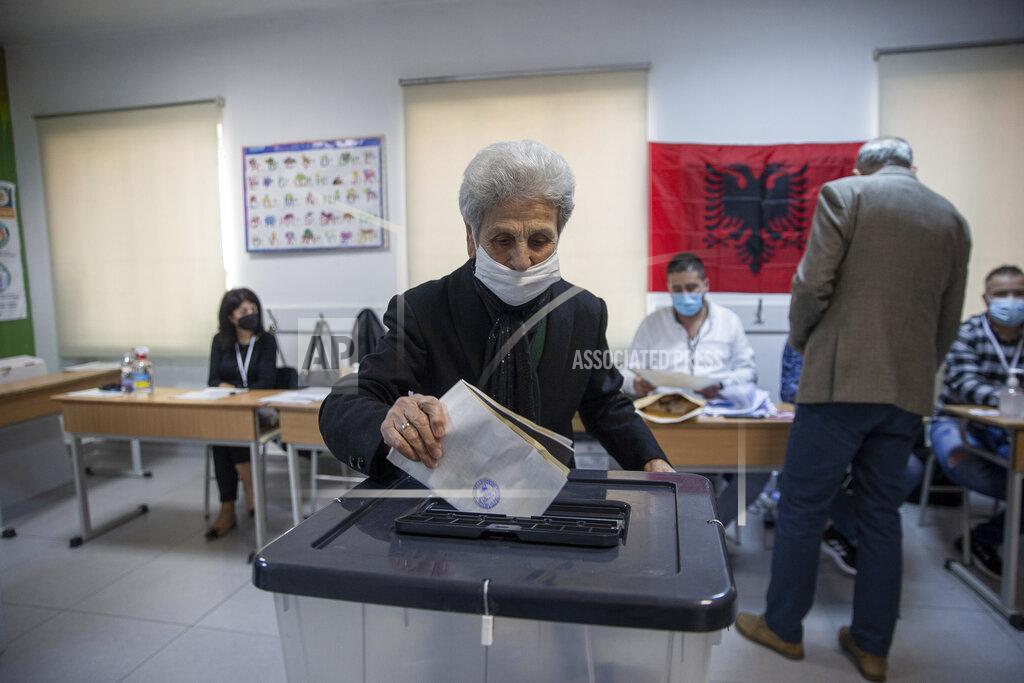 Visar Kryeziu A woman casts her ballot during parliamentary elections in capital Tirana, Albania, Sunday, April 25, 2021. Albanians are voting in parliamentary elections amid the virus pandemic and a bitter political rivalry between the two largest political parties. (AP Photo/Visar Kryeziu)