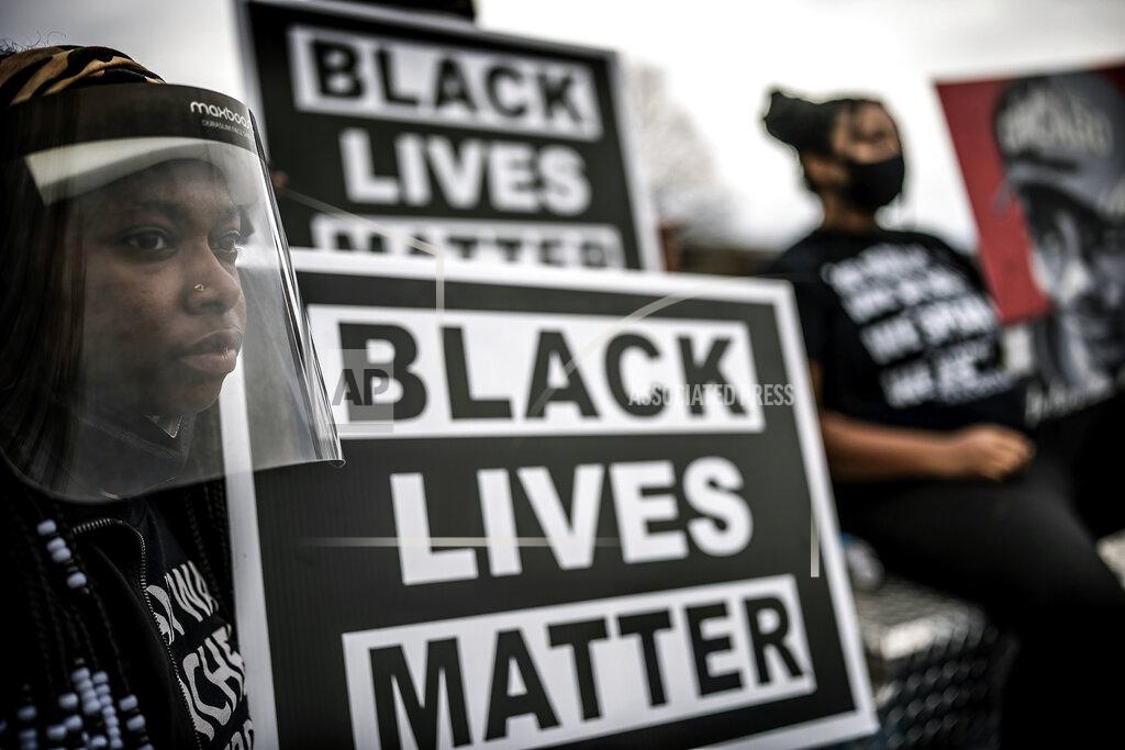 Jerry Holt Amyna Price, 26, of Birmingham, Ala., marches to the Brooklyn Center Police Department in Brooklyn Center, Minn., Sunday, May 2, 2021. Hundreds of people joined Daunte Wright's family and friends on a march through the Minneapolis suburb where he was fatally shot by a police officer during a traffic stop three weeks earlier. (Jerry Holt/Star Tribune via AP)