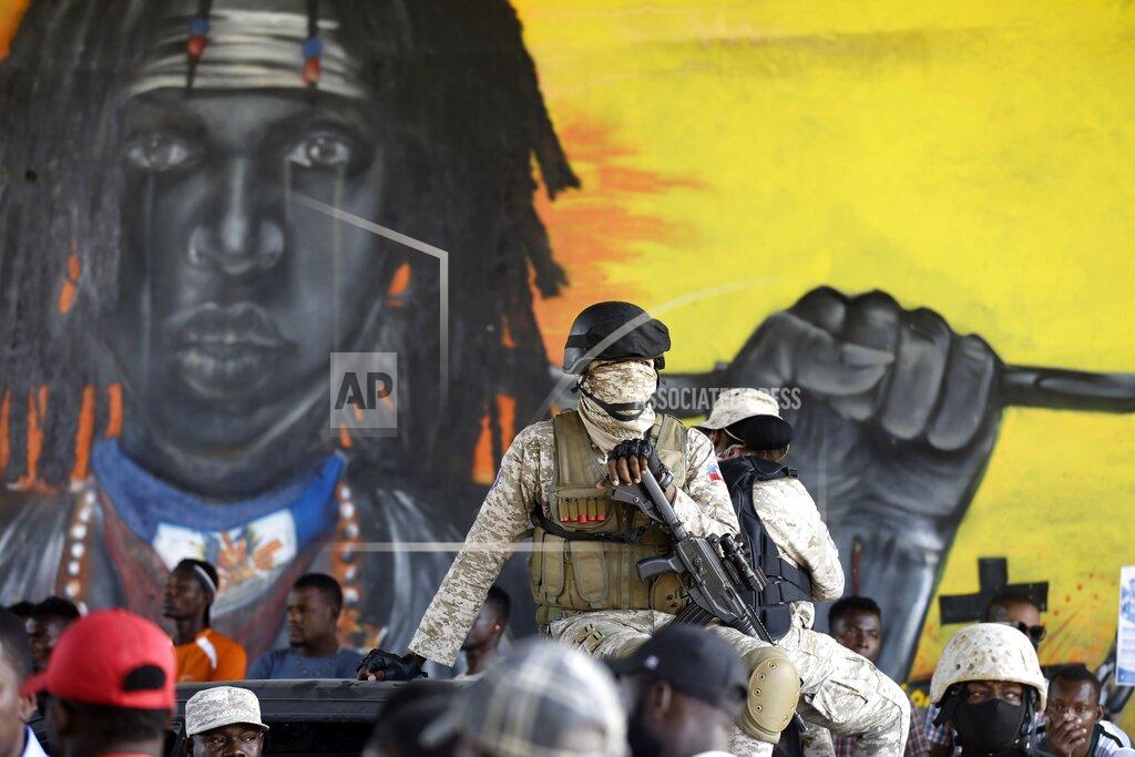 Dieu Nalio Chery A police officers sits on the roof of his vehicle during a protest to demand the resignation of Haiti's president Jovenel Moise in Port-au-Prince, Haiti, Wednesday, Jan. 20, 2021. Moise has one more year in power, but a growing groundswell of opposition is organizing protests and demanding he resign next month amid spiraling crime and a crumbling economy. ( AP Photo/ Dieu Nalio Chery)