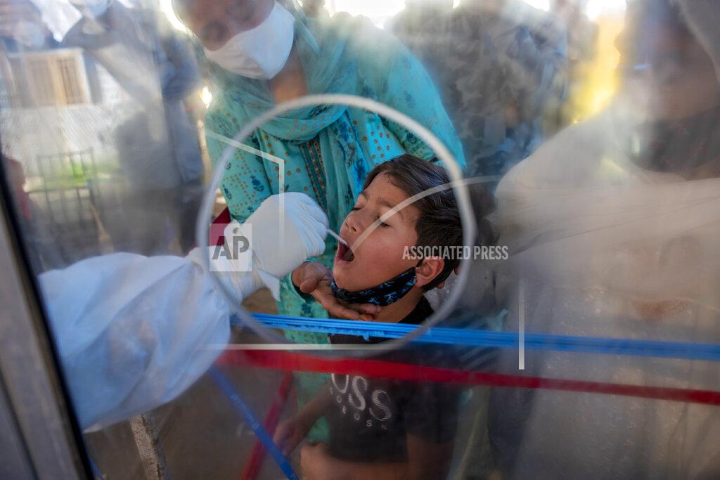 Dar Yasin A health worker takes a mouth swab sample of a Kashmiri boy to test for COVID-19 in Srinagar, Indian controlled Kashmir, Saturday, May 8, 2021. Infections have swelled in India since February in a disastrous turn blamed on more contagious variants as well as government decisions to allow massive crowds to gather for religious festivals and political rallies. (AP Photo/ Dar Yasin)
