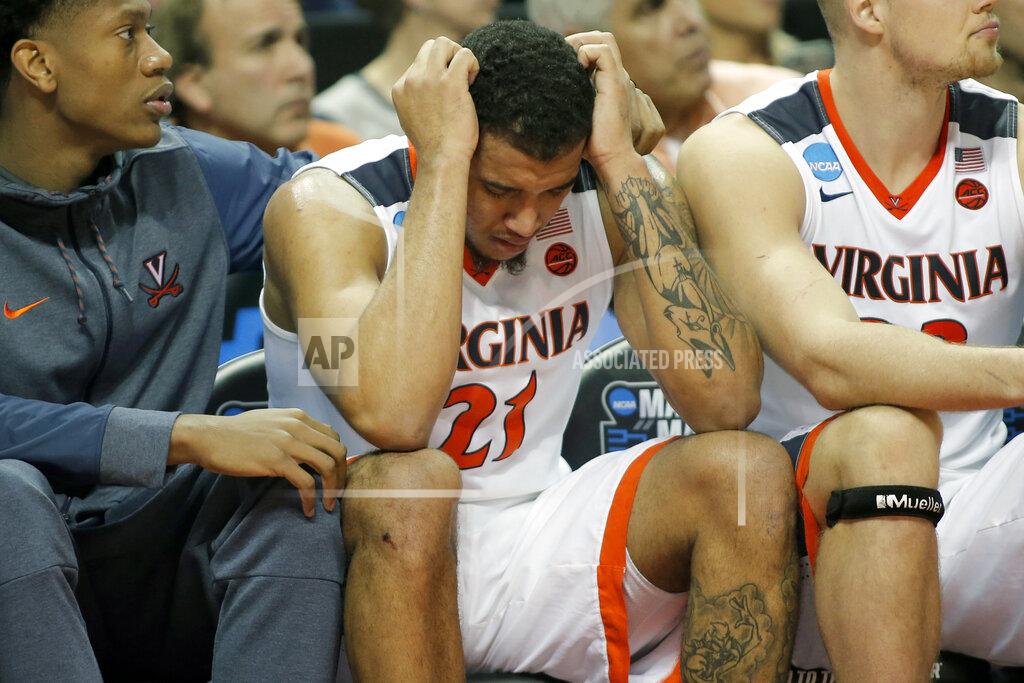 Bob Leverone FILE - In this March 16, 2018, file photo, Virginia's Isaiah Wilkins (21) is consoled after fouling out during the second half of the team's first-round game against UMBC in the NCAA men's college basketball tournament in Charlotte, N.C. Virginia lost to UMBC 74-54. (AP Photo/Bob Leverone, File)