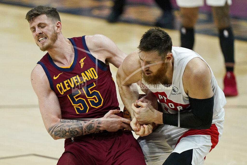 Tony Dejak Cleveland Cavaliers Isaiah Hartenstein, left, and Toronto Raptors' Aron Baynes battle for the ball in the second half of an NBA basketball game, Saturday, April 10, 2021, in Cleveland. (AP Photo/Tony Dejak)