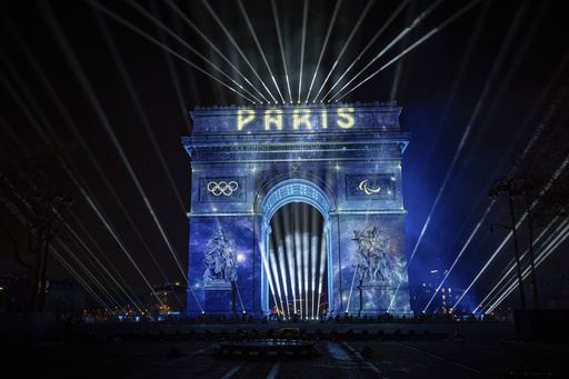 A light show is projected on the Arc de Triomphe during New Year celebrations on the Champs Elysees in Paris, France, Monday, Jan. 1, 2024, (AP Photo/Aurelien Morissard)