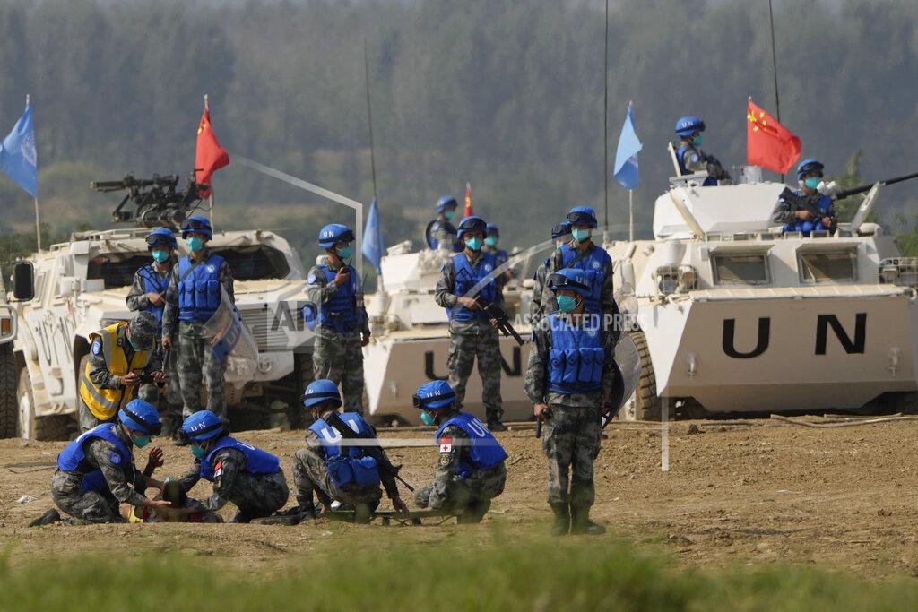 Ng Han Guan United Nations troop tend to a participant playing the role of injured civilian during a scenario where they pacify local civilians fighting over water resource during the Shared Destiny 2021 drill at the Queshan Peacekeeping Operation training base in Queshan County in central China's Henan province Wednesday, Sept. 15, 2021. Peacekeeping troops from China, Thailand, Mongolia and Pakistan took part in the 10 days long exercise that field reconnaissance, armed escort, response to terrorist attacks, medical evacuation and epidemic control. (AP Photo/Ng Han Guan)