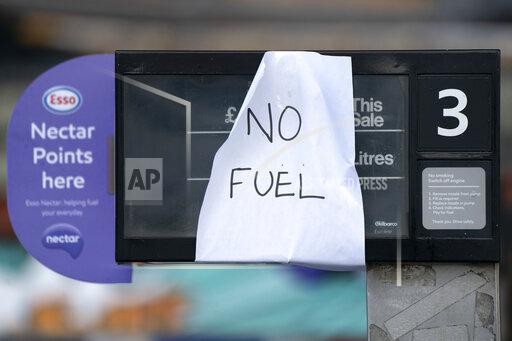 A sign indicating that fuel has run out is seen at a petrol station in Manchester, Monday, Sept. 27, 2021. British Prime Minister Boris Johnson is said to be considering whether to call in the army to deliver fuel to petrol stations as pumps ran dry after days of panic buying. ( AP Photo/Jon Super)