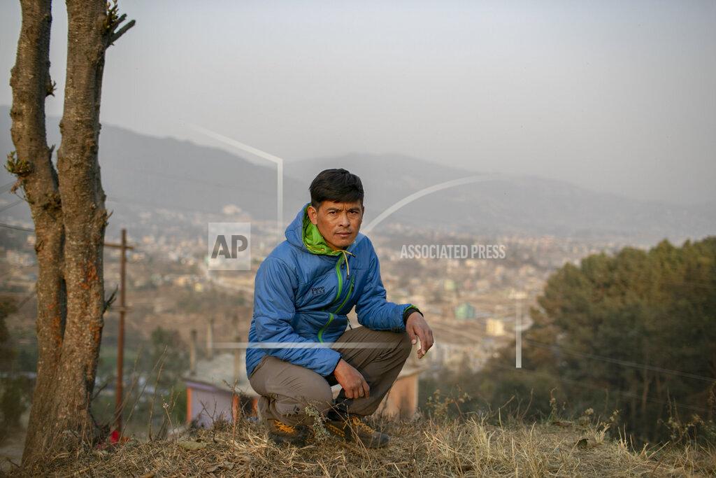 Niranjan Shrestha Pasang Rinzee Sherpa, 33, mountain guide poses for a photograph in Kathmandu, Nepal, Wednesday, March 3, 2021. Sherpa has scaled Mount Everest twice and spent 18 years helping climbers up the highest Himalayan peaks, generally earning about $8,000 a year. In the past 12 months, he had no income. (AP Photo/Niranjan Shrestha)