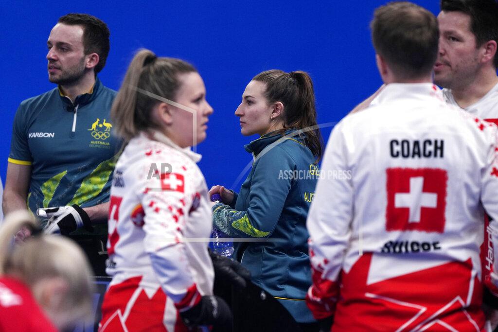 Australia's Tahli Gill and Dean Hewitt, take a break, as they compete against Switzerland during the mixed doubles curling match, at the 2022 Winter Olympics, Sunday, Feb. 6, 2022, in Beijing. (AP Photo/Nariman El-Mofty)