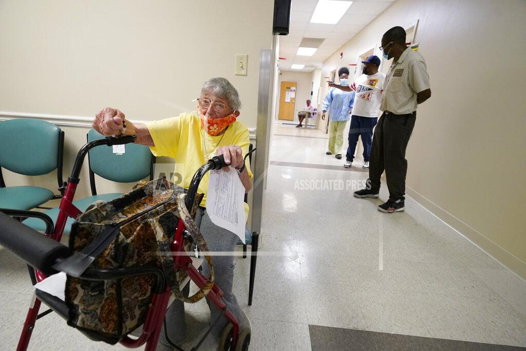 Rogelio V. Solis Linda Busby, 74, waits to receive her Johnson & Johnson COVID-19 vaccine at the Aaron E. Henry Community Health Service Center, Wednesday, April 7, 2021, in Clarksdale, Miss. Busby joined a group of seniors from the Rev. S.L.A. Jones Activity Center for the Elderly that were given a ride to the health center for their vaccinations. The Mississippi Department of Human Services is in the initial stages of teaming up with community senior services statewide to help older residents get vaccinated. (AP Photo/Rogelio V. Solis)