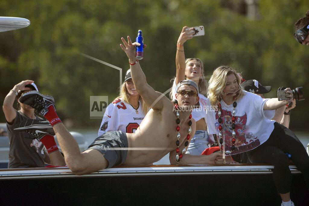 Phelan Ebenhack Tampa Bay Buccaneers NFL football tight end Rob Gronkowski waves during a celebration of their Super Bowl 55 victory over the Kansas City Chiefs with a boat parade in Tampa, Fla., Wednesday, Feb. 10, 2021. (AP Photo/Phelan Ebenhack)