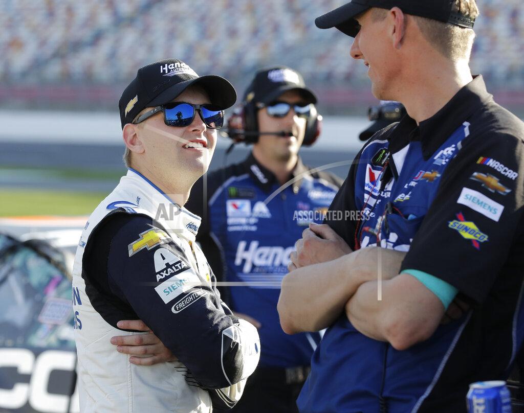 Chuck Burton Alex Bowman, left, talks with cree members before qualifying for Saturday's NASCAR All-Star Cup series auto race at Charlotte Motor Speedway in Concord, N.C., Friday, May 17, 2019. (AP Photo/Chuck Burton)