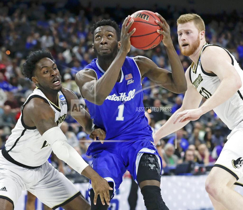 John Raoux Seton Hall's Michael Nzei (1) looks for a shot as he gets between Wofford's Tray Hollowell, left, and Matthew Pegram during the first half of a first-round game in the NCAA men’s college basketball tournament in Jacksonville, Fla., Thursday, March 21, 2019. (AP Photo/John Raoux)