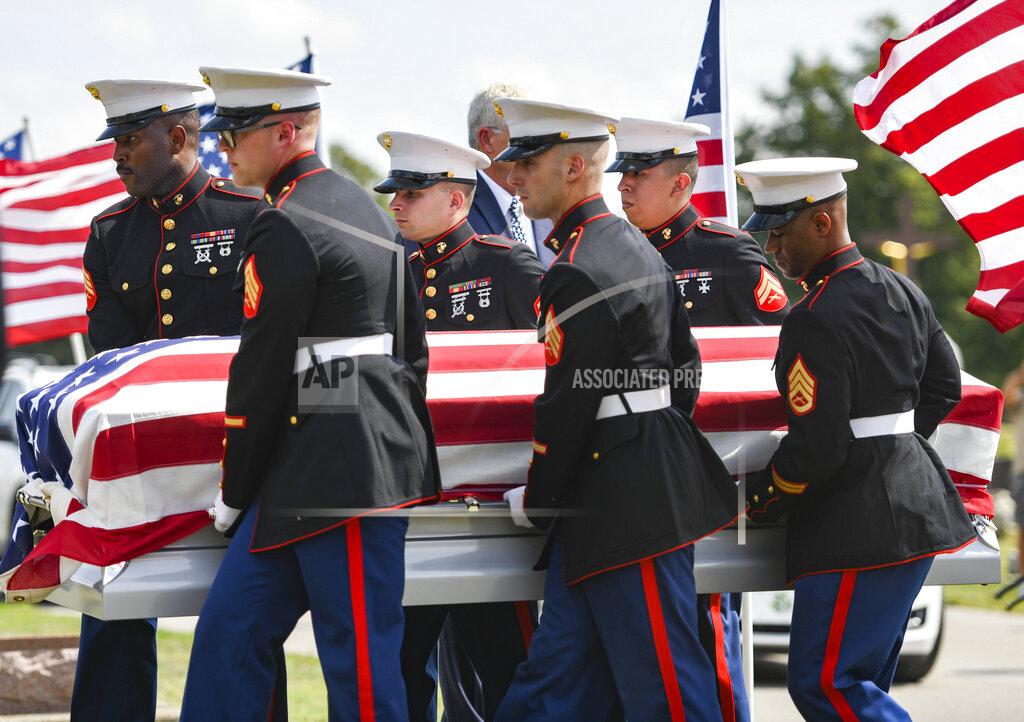 Jonah Hinebaugh Marine honor guards carry Marine Cpl. Humberto Sanchez' casket during the graveside service at Mt. Hope Cemetery in Logansport, Ind., on Tuesday, Sept. 14, 2021. Sanchez was one of 13 U.S. service members killed in last month's suicide bombing at Afghanistan’s Kabul airport during the U.S.-led evacuation. (Jonah Hinebaugh/The Pharos-Tribune via AP)