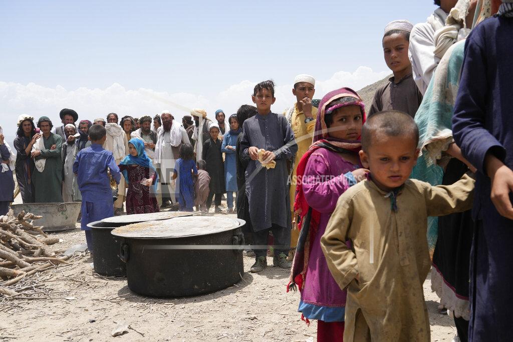 Ebrahim Noroozi Afghans receive aid at a camp after an earthquake in Gayan district in Paktika province, Afghanistan, Sunday, June 26, 2022. A powerful earthquake struck a rugged, mountainous region of eastern Afghanistan early Wednesday, flattening stone and mud-brick homes in the country's deadliest quake in two decades, the state-run news agency reported. (AP Photo/Ebrahim Nooroozi)