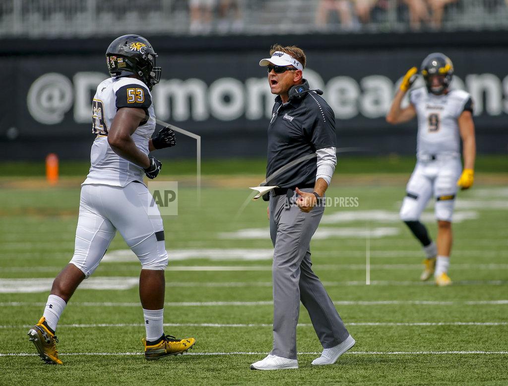 Nell Redmond Towson coach Rob Ambrose talks to defensive linesman Bryce Carter in the first half of an NCAA college football game against Wake Forest in Winston-Salem, N.C., Saturday, Sept. 8, 2018. (AP Photo/Nell Redmond)