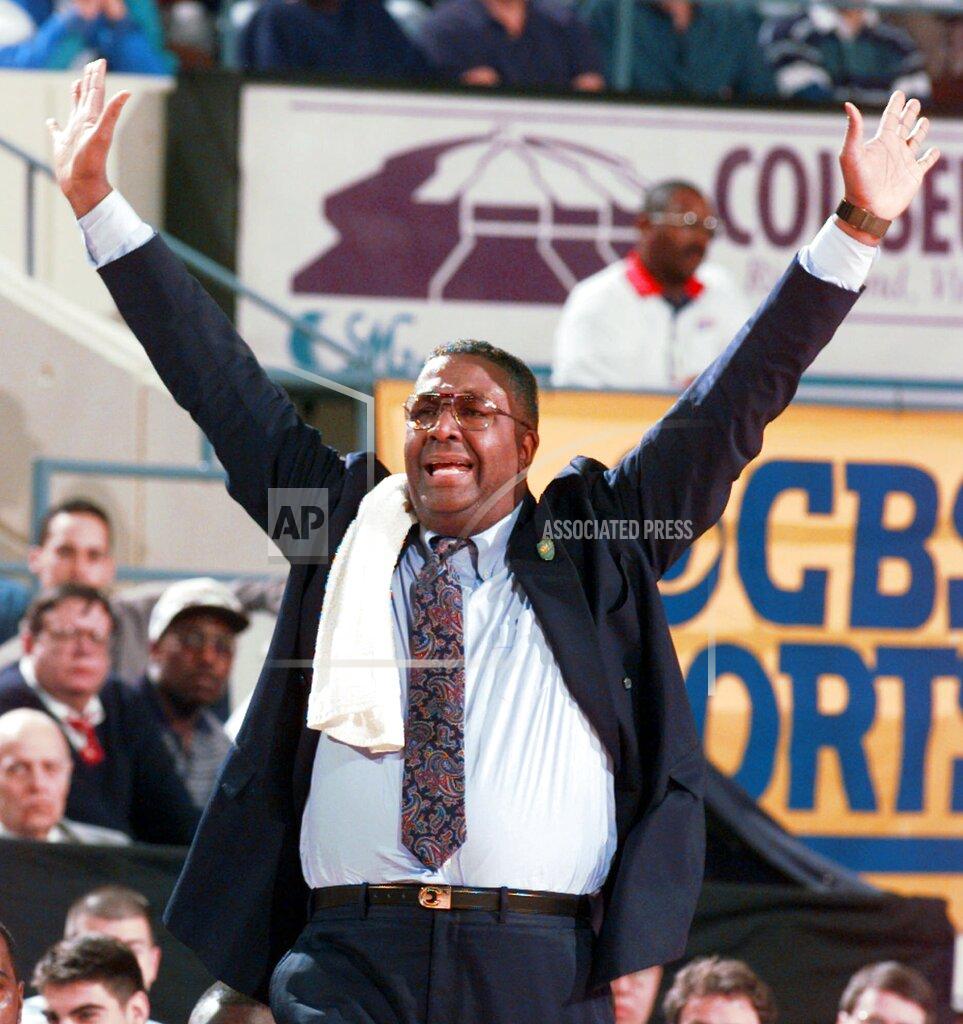 FILE - In this March 15, 1996, file photo, Georgetown head coach John Thompson yells to his players during the second half of a first round NCAA college basketball game at the Richmond Coliseum in Richmond, Va. John Thompson, the imposing Hall of Famer who turned Georgetown into a “Hoya Paranoia” powerhouse and became the first Black coach to lead a team to the NCAA men’s basketball championship, has died. He was 78 His death was announced in a family statement Monday., Aug. 31, 2020. No details were disclosed. (AP Photo/Doug Mills, File)
