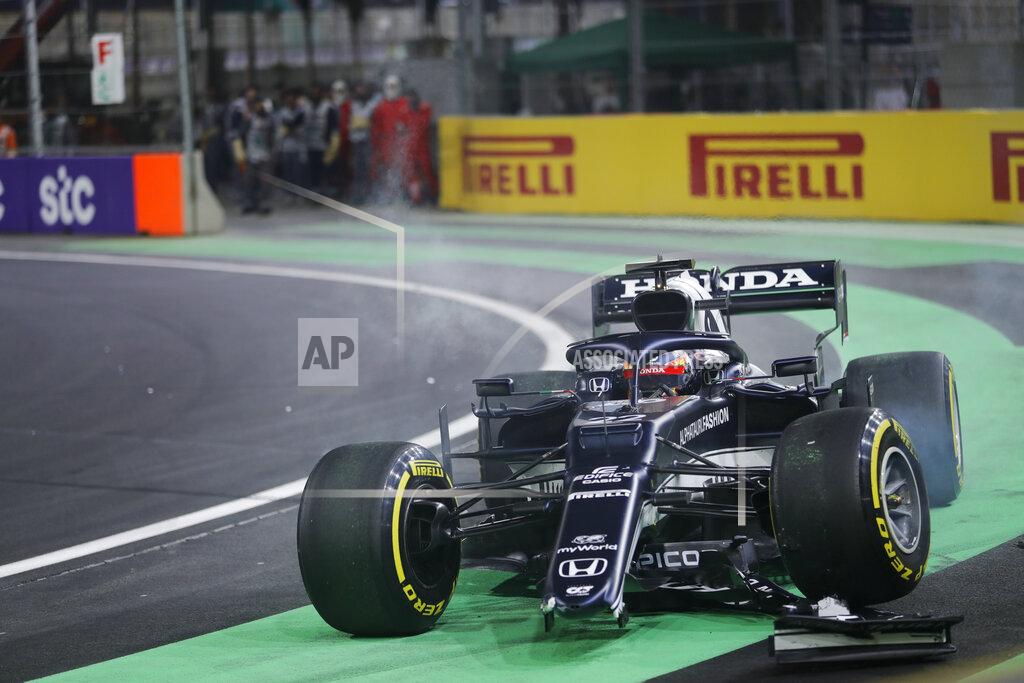 Amr Nabil Alpha Tauri Yuki Tsunoda of Japan crashes during the Formula One corniche circuit, in Jiddah, Saudi Arabia, Sunday, Dec. 5, 2021. (AP Photo/Amr Nabil)