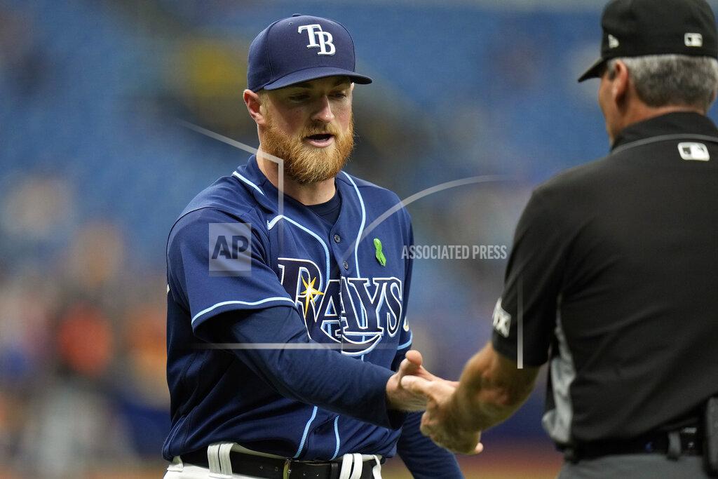 Chris O'MEara Tampa Bay Rays starting pitcher Drew Rasmussen gets his hands checked by first base umpire Angel Hernandez for foreign substances during the fourth inning of a baseball game against the Detroit Tigers Wednesday, May 18, 2022, in St. Petersburg, Fla. (AP Photo/Chris O'Meara)