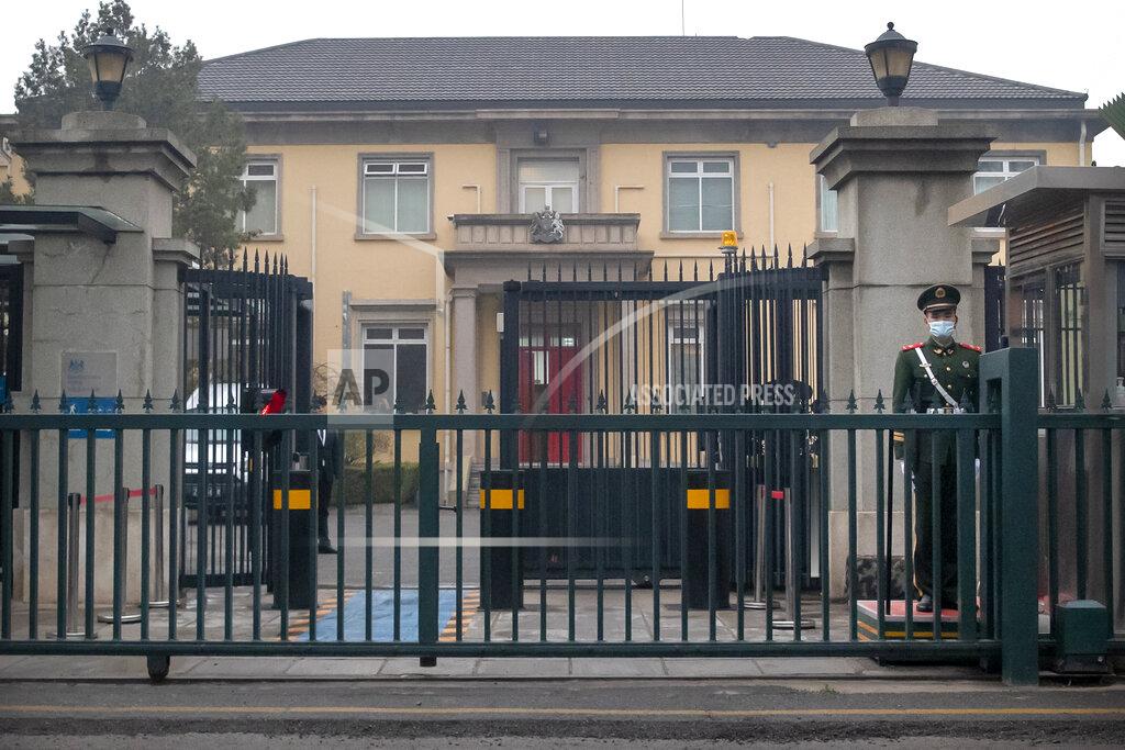 Mark Schiefelbein A Chinese paramilitary police officer stands guard outside the British Embassy in Beijing, Friday, March 26, 2021. China has announced sanctions on British individuals and entities following the U.K.'s joining the EU and others in sanctioning Chinese officials accused of human rights abuses in the Xinjiang region. (AP Photo/Mark Schiefelbein)