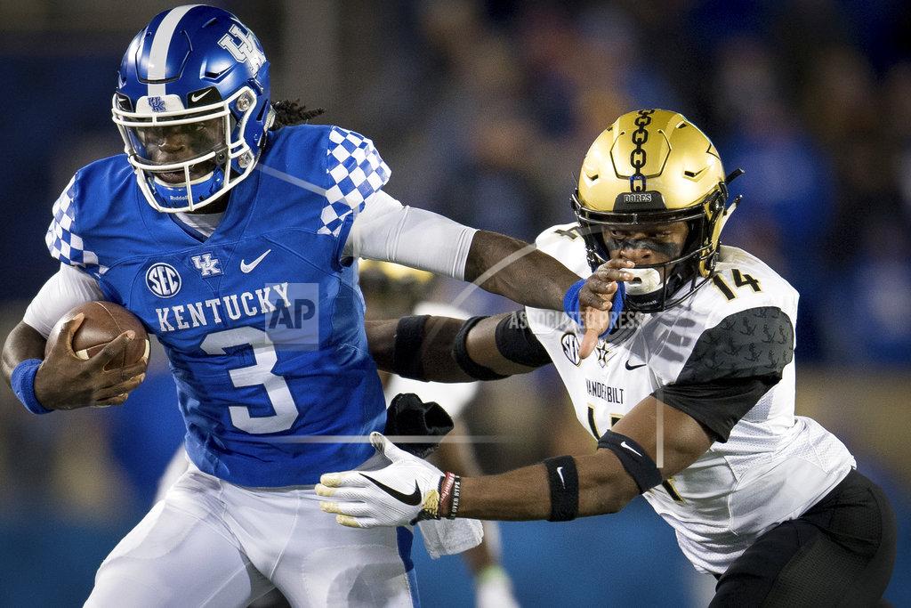 Bryan Woolston Kentucky quarterback Terry Wilson (3) is tackled by Vanderbilt defensive back Max Worship (14) during the second half of an NCAA college football game in Lexington, Ky., Saturday, Oct. 20, 2018. Kentucky won, 14-7. (AP Photo/Bryan Woolston)