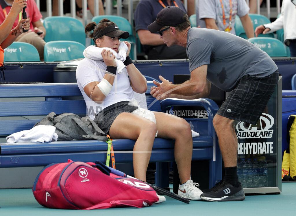 Lynne Sladky FILE - In this March 21, 2019 file photo, Bianca Andreescu, of Canada, left, talks with her coach Sylvain Bruneau during her match against Irina Camelia Begu, of Romania, at the Miami Open tennis tournament in Miami Gardens, Fla. Bruneau has released a statement, Sunday, Jan. 17, 2021, saying he was the positive coronavirus case aboard the flight from Abu Dhabi to Melbourne and he had followed all protocols and procedures, including producing a negative test within 72 hours before the flight departure and has "no idea how I might have contracted the virus." (AP Photo/Lynne Sladky, File)
