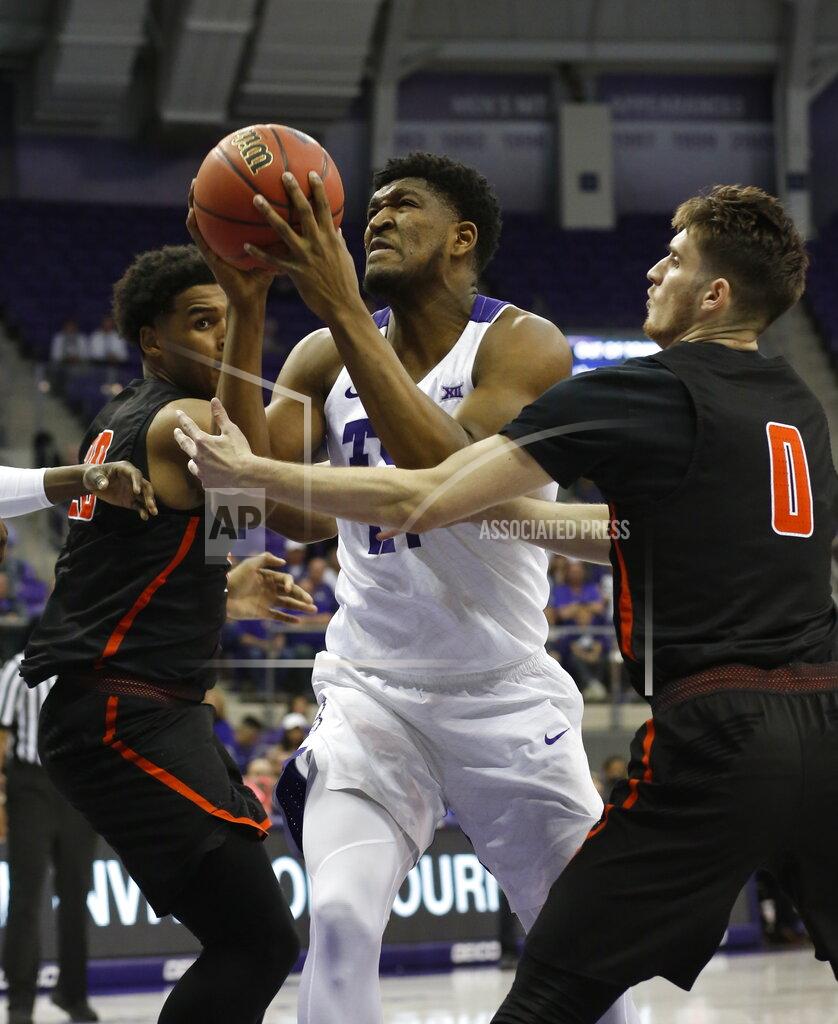 David Kent TCU center Kevin Samuel (21) shoots between Sam Houston State forward Kai Mitchell (20) and guard Albert Almanza (0) during the first half of an NCAA college basketball game in the NIT on Wednesday, March 20, 2019, in Fort Worth, Texas. (David Kent/Star-Telegram via AP)